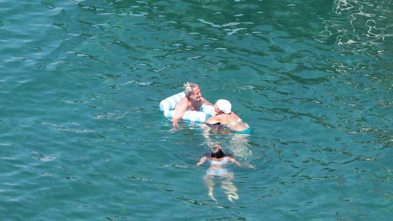 Family enjoying a swim in the ocean