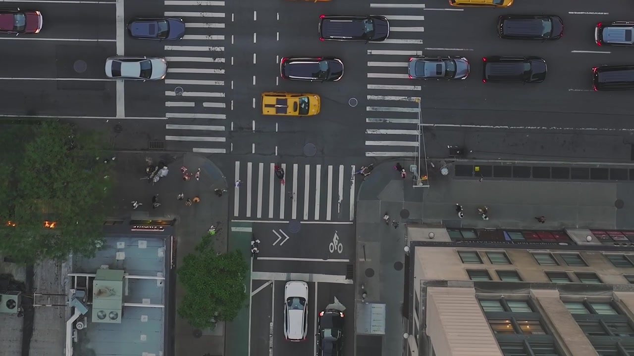 Traffic flows through busy streets in New York City during daytime