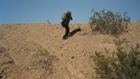 united states marines | special forces soldier in combat | walking forward with weapons ready | tactically walking through middle eastern desert | 1 of 3