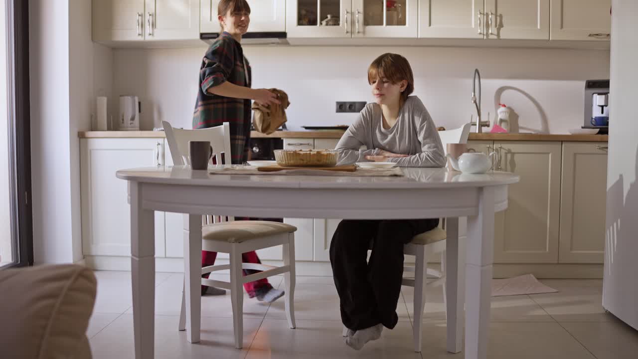 Family gathering around a pie in the kitchen