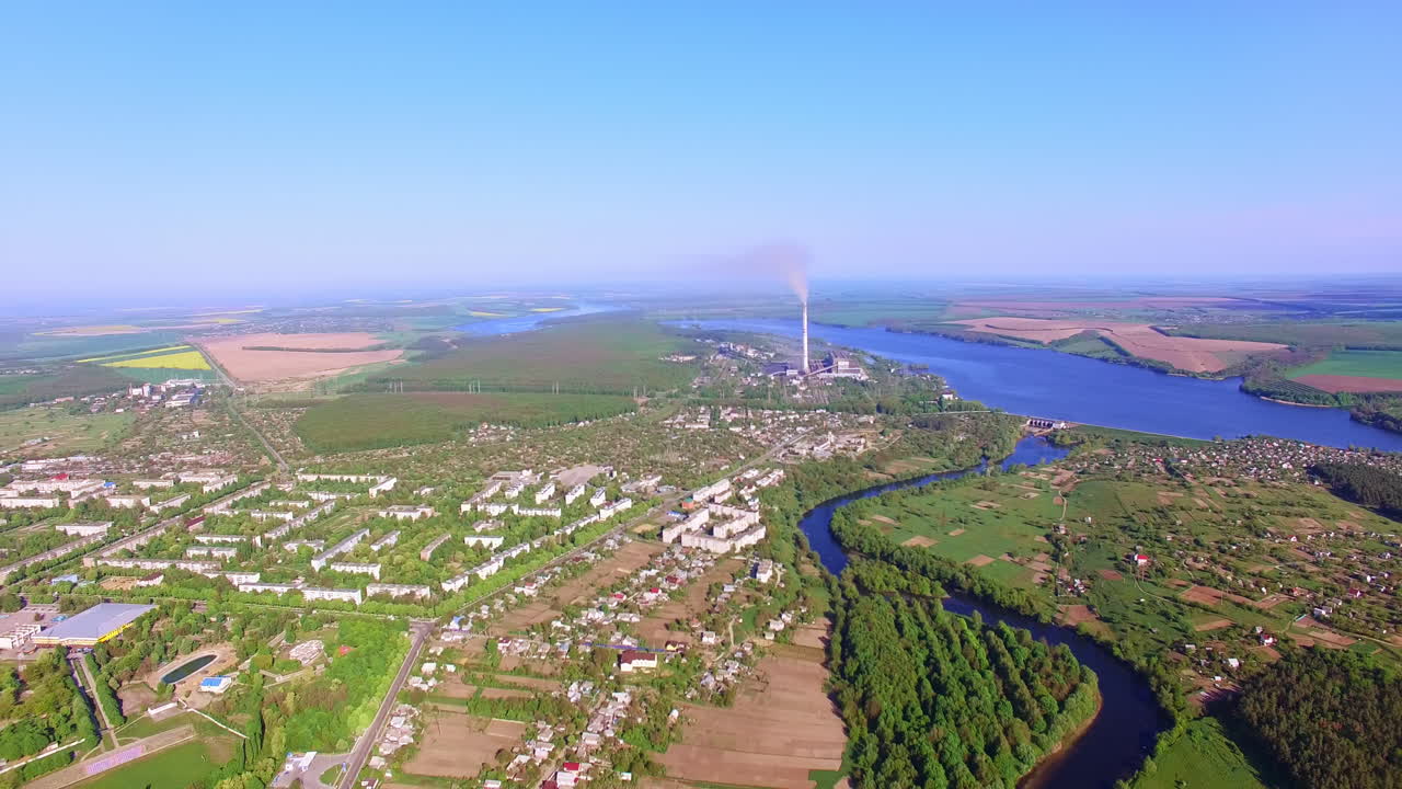 Amazing scenery of a city situated on the banks of beautiful river. Sunny day shot at the backdrop of blue clear sky.