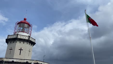 portugal national flag is waving in the cloudy and windy sky