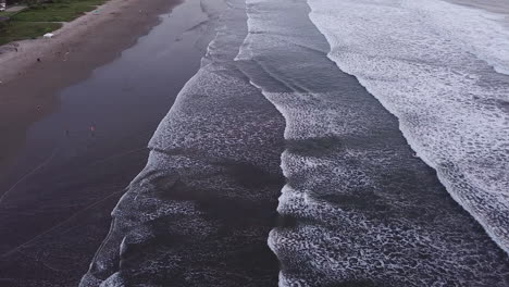 Drone-Flying-Through-Scenic-Waves-With-Tourist-At-Coastline-During-Summer-In-Olon-Beach,-Ecuador