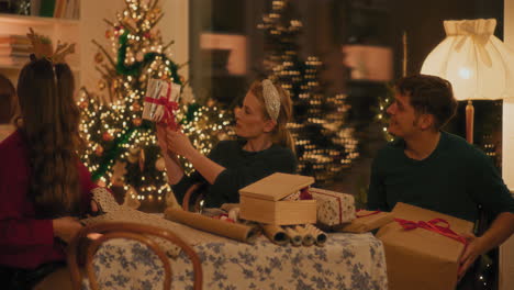 woman showing gift to male and female friends