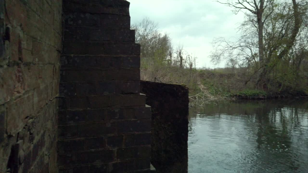 Pan shot out to a small river in the English countryside