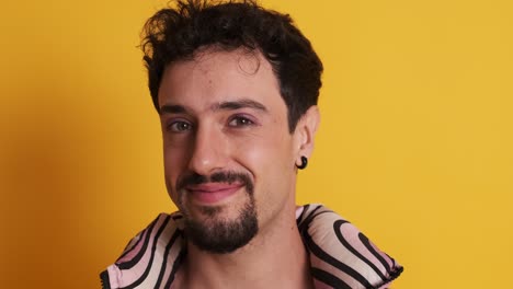 gay man in make up posing while smiling at the camera