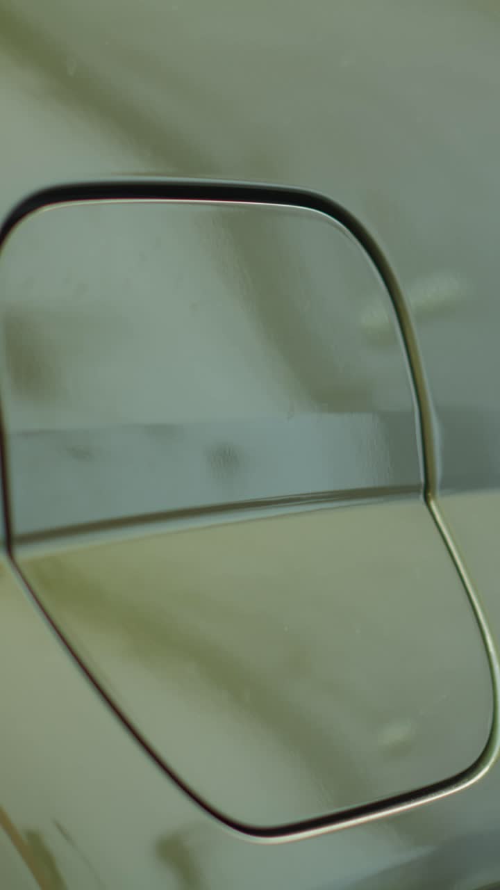 Vertical video Close up of driver opening EV car charging port flap to charge battery