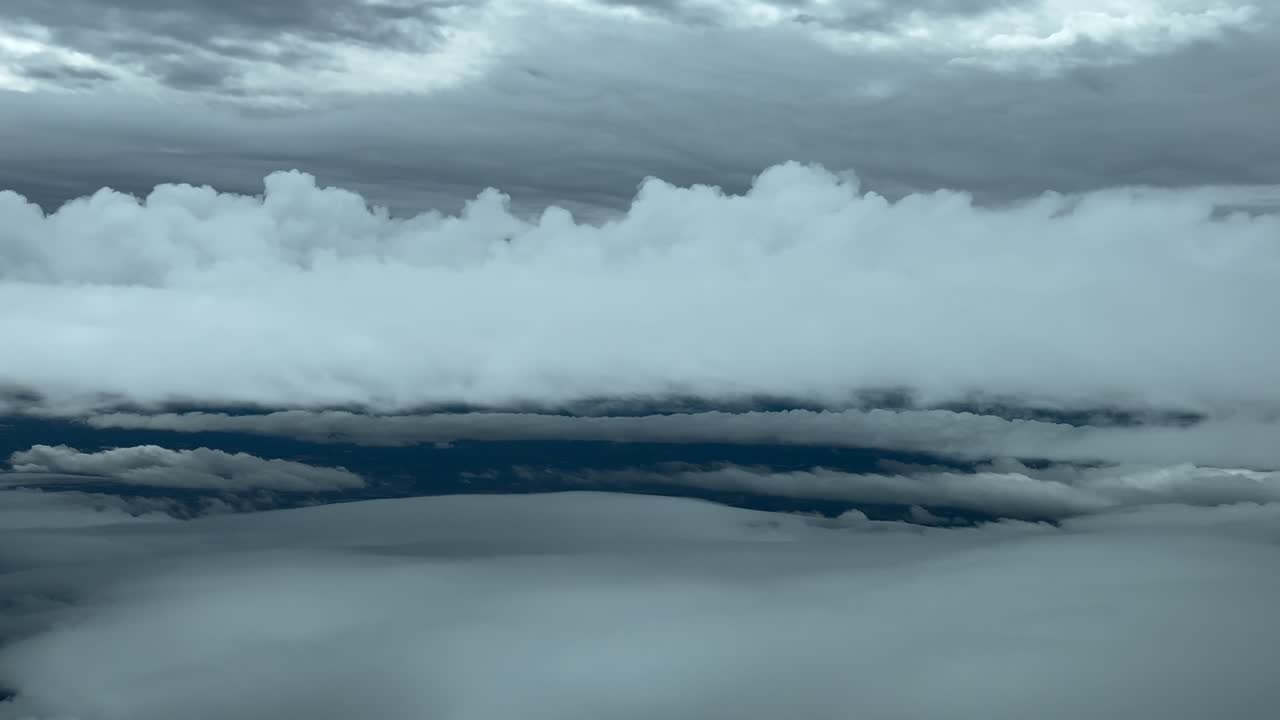 Pilot’s POV FPV real time flight through layers of grey stratus clouds in a winter sky, as seen by the pilots from the cockpit of a jet. Immersive pilot’s perspective POV FPV