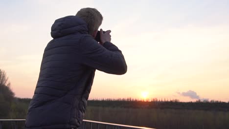 a person is taking photos while standing on a viewing platform