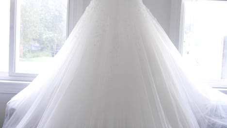 brides dress hanging before ceremony