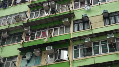 close-up shot of green residential building facade in hong kong