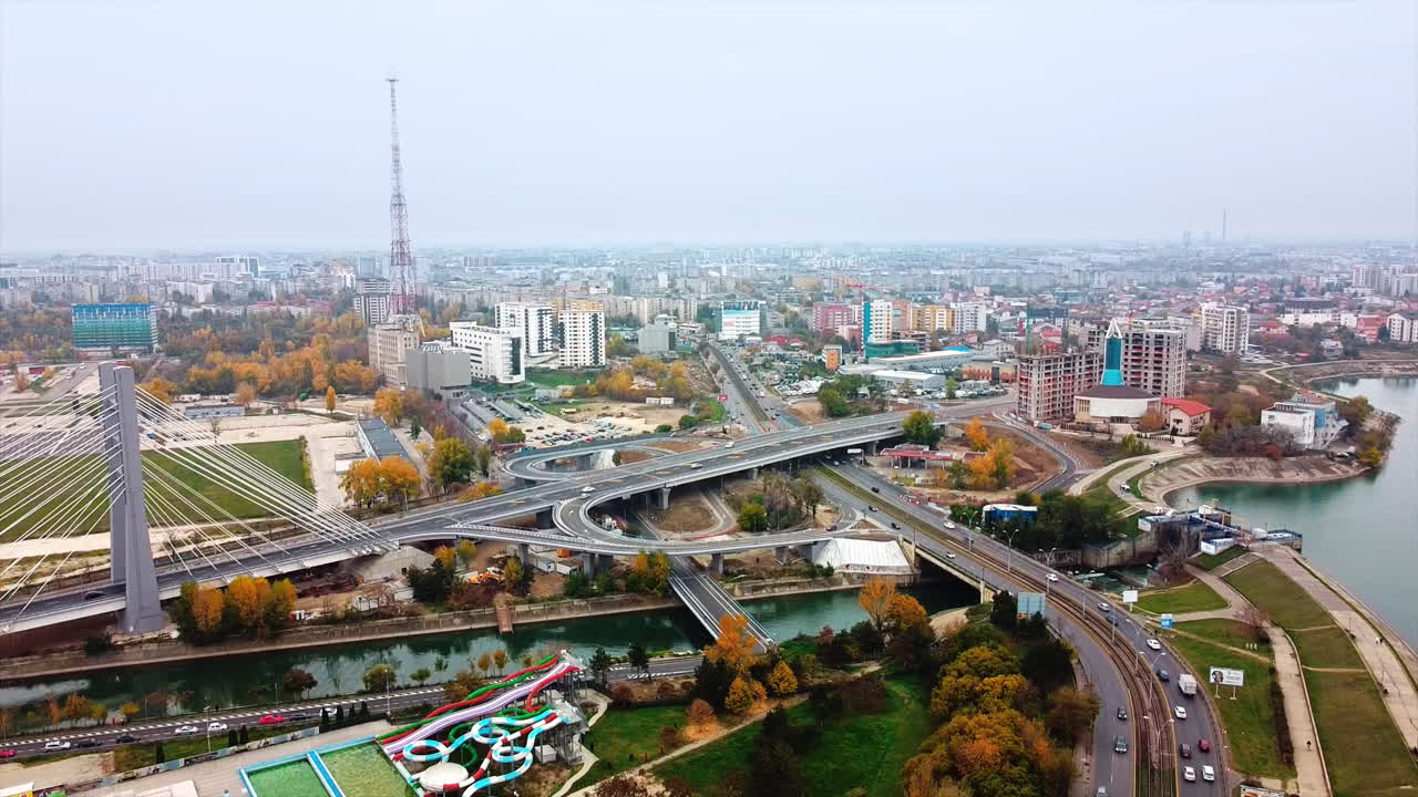 Ciurel passage, bridge over a river with moving cars, construction works near it. View from the drone. Bucharest, Romania