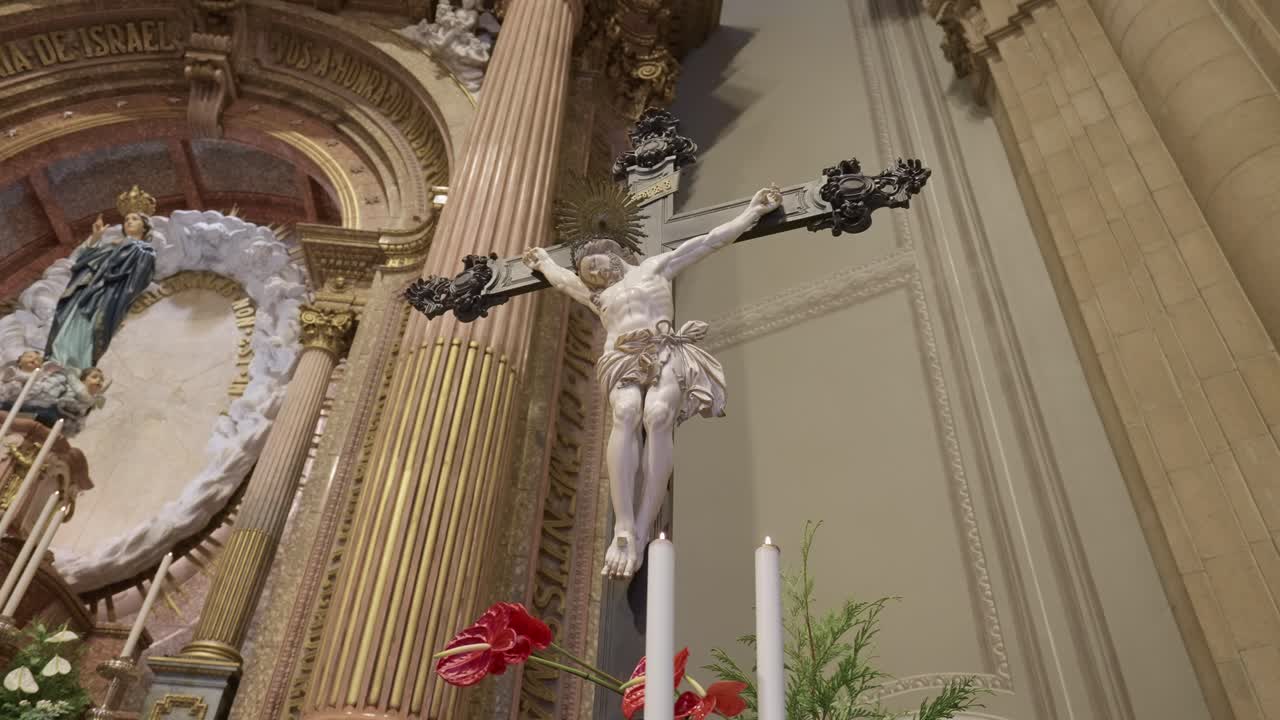 Close view of Jesus Christ on crucifix with baroque altar details