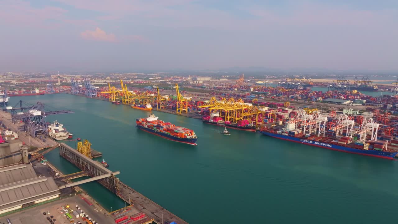Drone view of cargo vessel departing port, Thailand