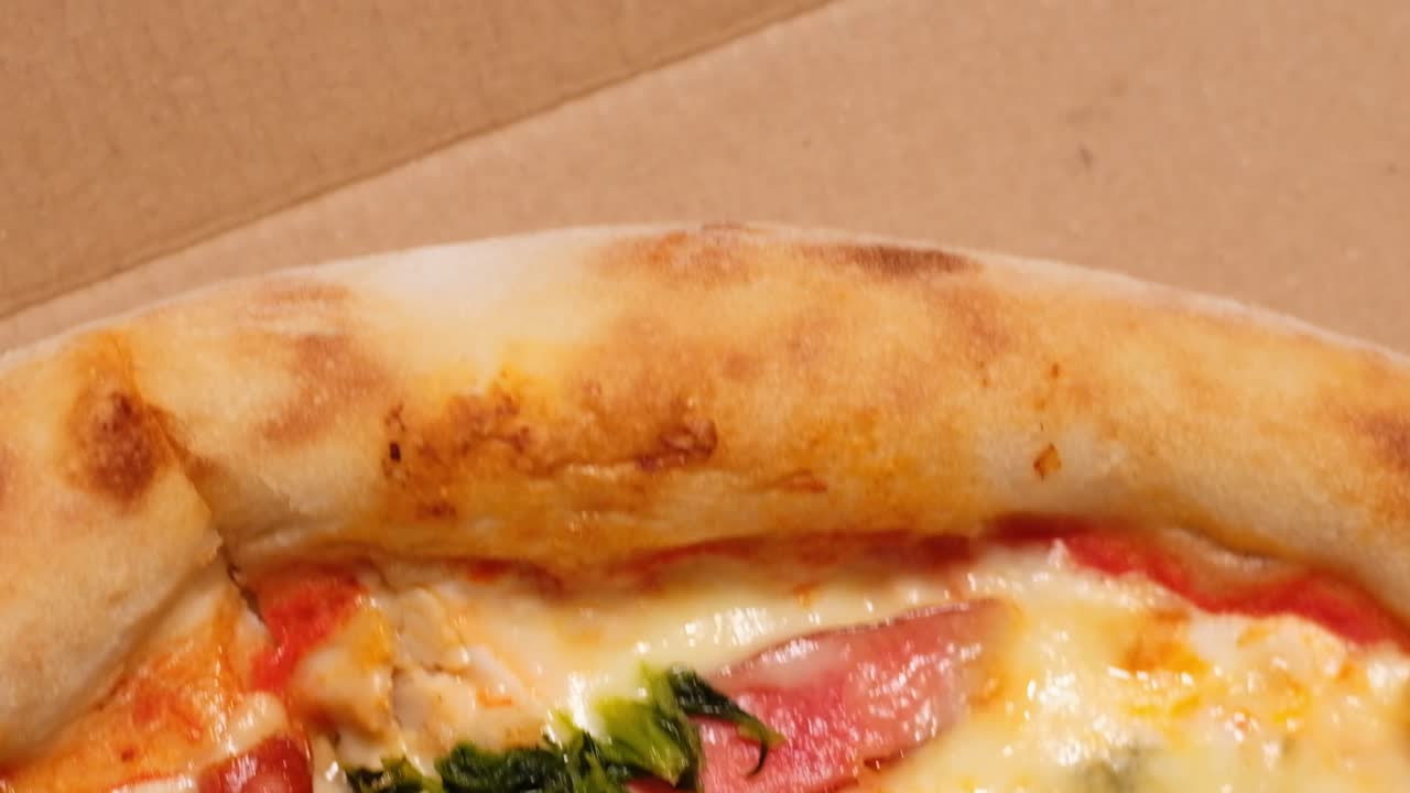 Close up view from above of pizza with hunter sausage in warm light