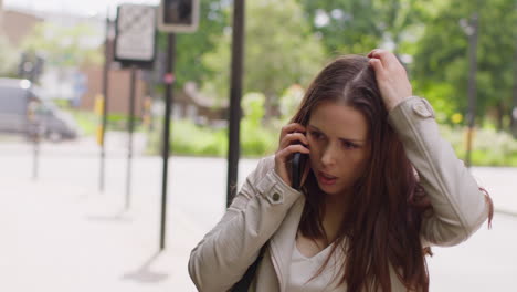 Stressed-Or-Angry-Woman-Outdoors-With-Financial-Worries-About-Cost-Of-Living-Crisis-Debt-And-Paying-Bills-Talking-On-Mobile-Phone-1