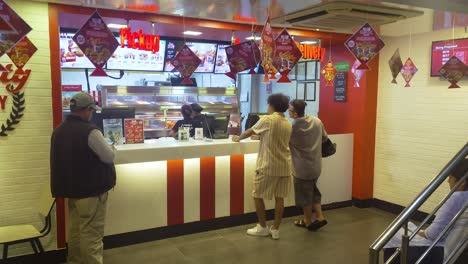 customers ordering food at a busy kfc restaurant