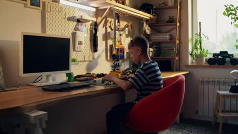 boy working on a project in his home study