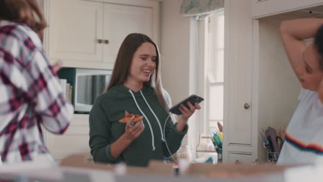 happy-teenage-girls-dancing-in-kitchen-eating-pizza-having-fun-celebrating-together-enjoying-hanging-out-on-weekend