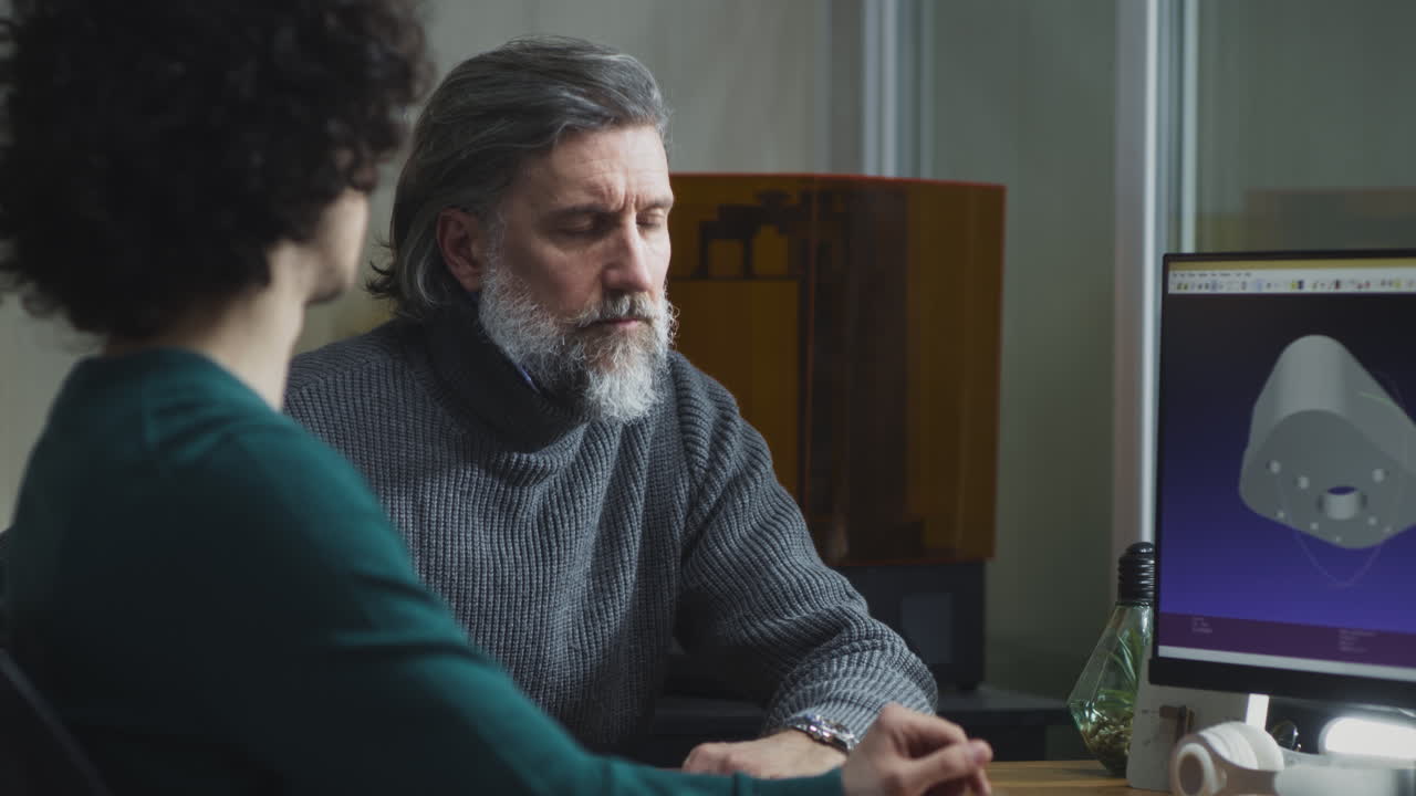 Two engineers or designers collaborating on a 3D design project