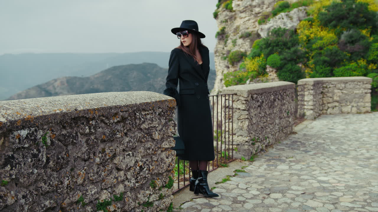 Woman In Total Black With Sunglasses Admiring The Nature Surrounding Her