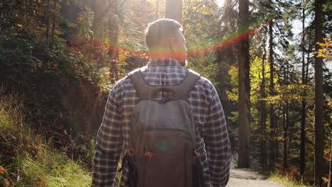 man hiking in autumn forest