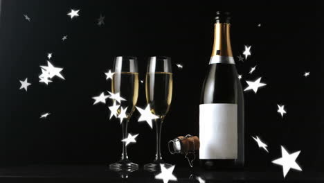 animation of stars falling over glasses of champagne on black background