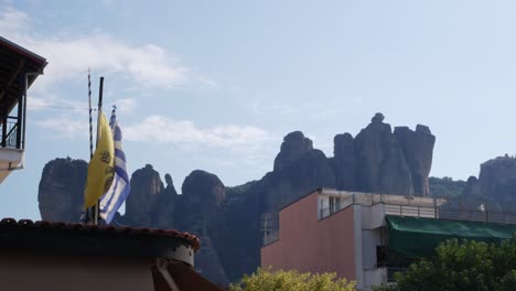 locked shot of meteora mountains and greek flag in kalampaka, greece