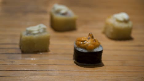 sushi rolls on wooden table with chopsticks