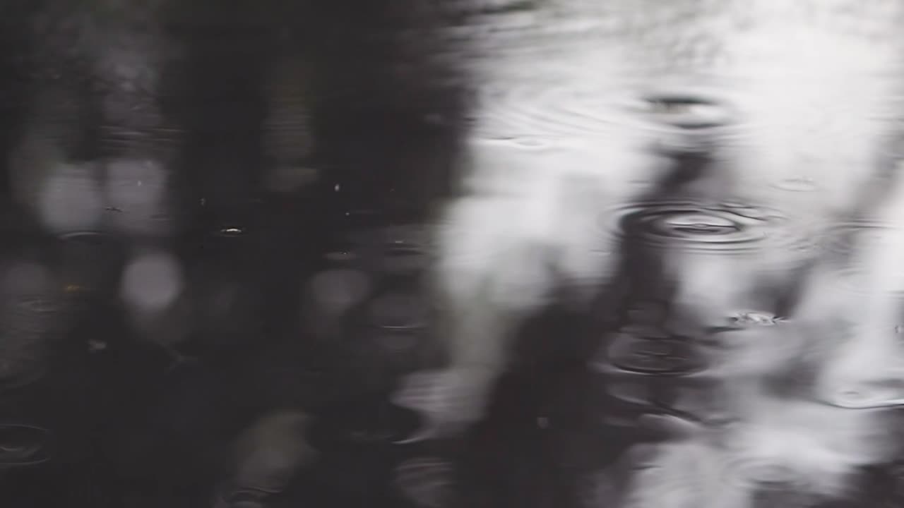 Close up of rain drops hitting ground during rainy day