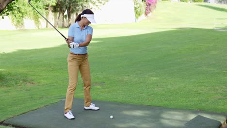 Young-female-golfer-preparing-to-tee-off