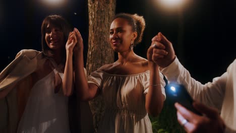friends dancing outdoors at night