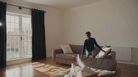 happy child jumping on a couch