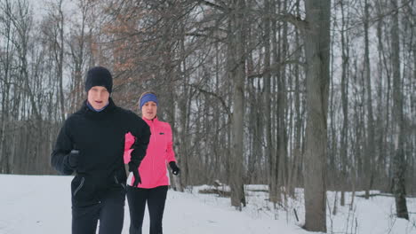 Happy-young-couple-married-sports-morning-and-evening-jogging-in-the-park.