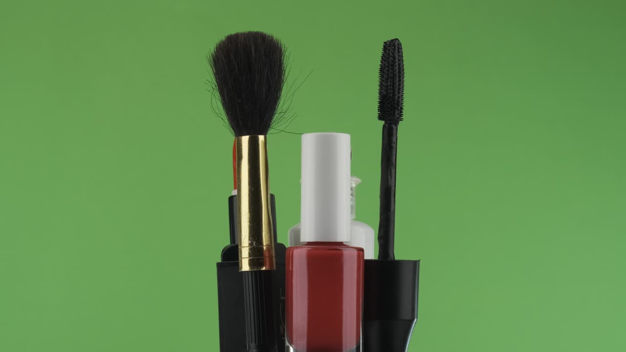 Rotation of cosmetics on a green background.