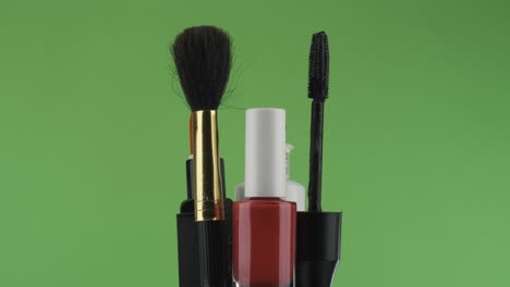 rotation of cosmetics on a green background.