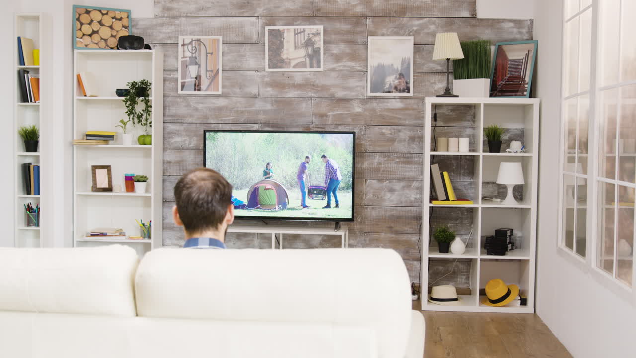 Living room scene with a man watching TV