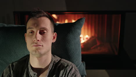 man relaxing by the fireplace