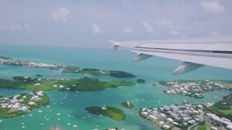 bermuda aerial takeoff view from plane window of st george's with turquoise water around islands in st george's harbour