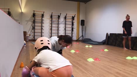 children learning roller skating in a gym