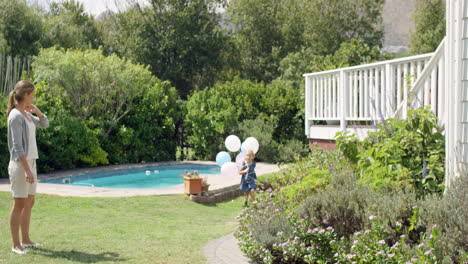 little blonde girl running with balloons in slow motion