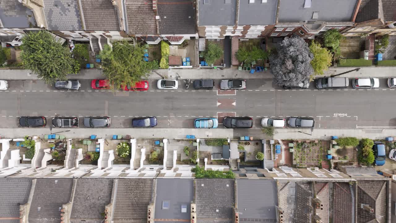 Top-down view of a residential street lined with terraced houses and vehicles, Peckham, London, UK, October 2024