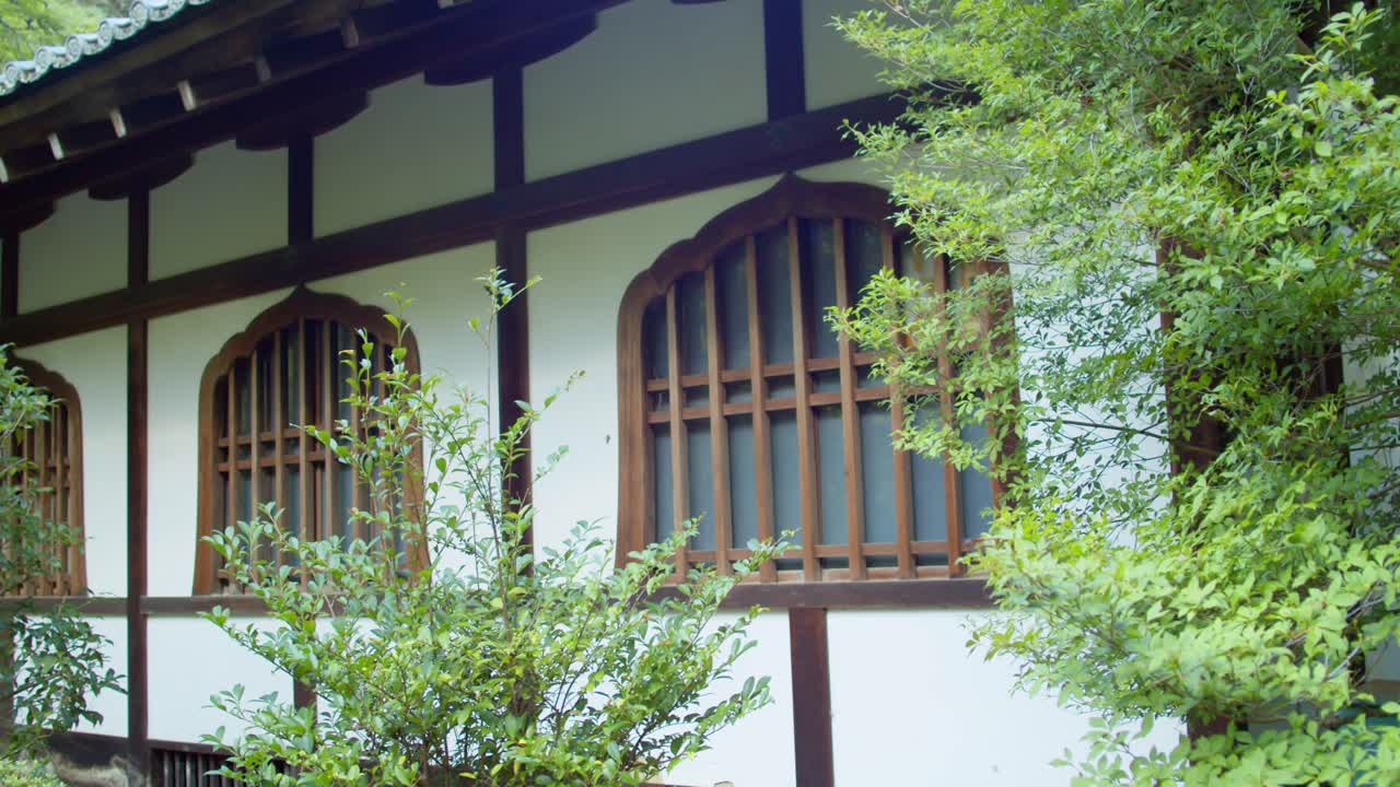 Beautiful architect of a window from an old temple in Kyoto, Japan soft lighting slow motion 4K