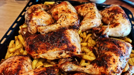 roasted chicken over french fries. - closeup shot