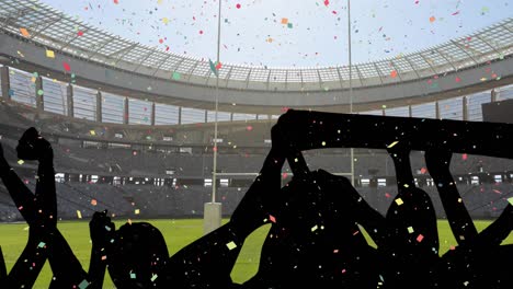 Buntes-Konfetti-Fällt-Gegen-Die-Silhouette-Jubelnder-Fans-Und-Das-Sportstadion-Im-Hintergrund