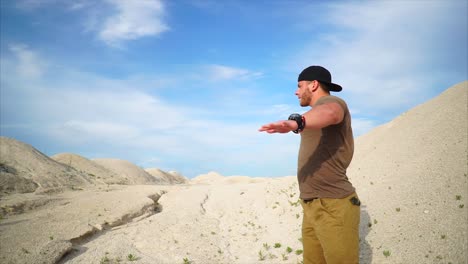 man stretching in a desert landscape