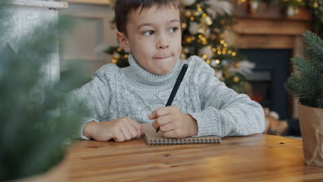 child writing a christmas letter