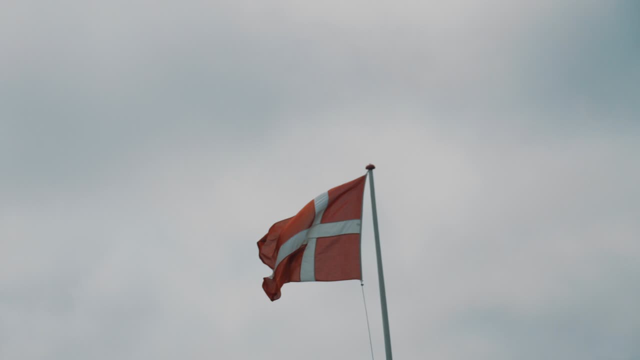 Danish flag flutters in the wind in slight slow motion