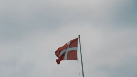 danish flag flutters in the wind in slight slow motion