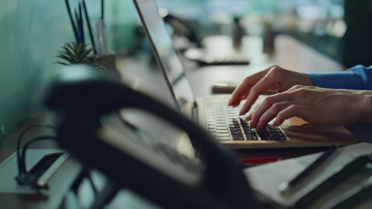 Employee hands typing keyboard laptop in office closeup. Unrecognizable woman